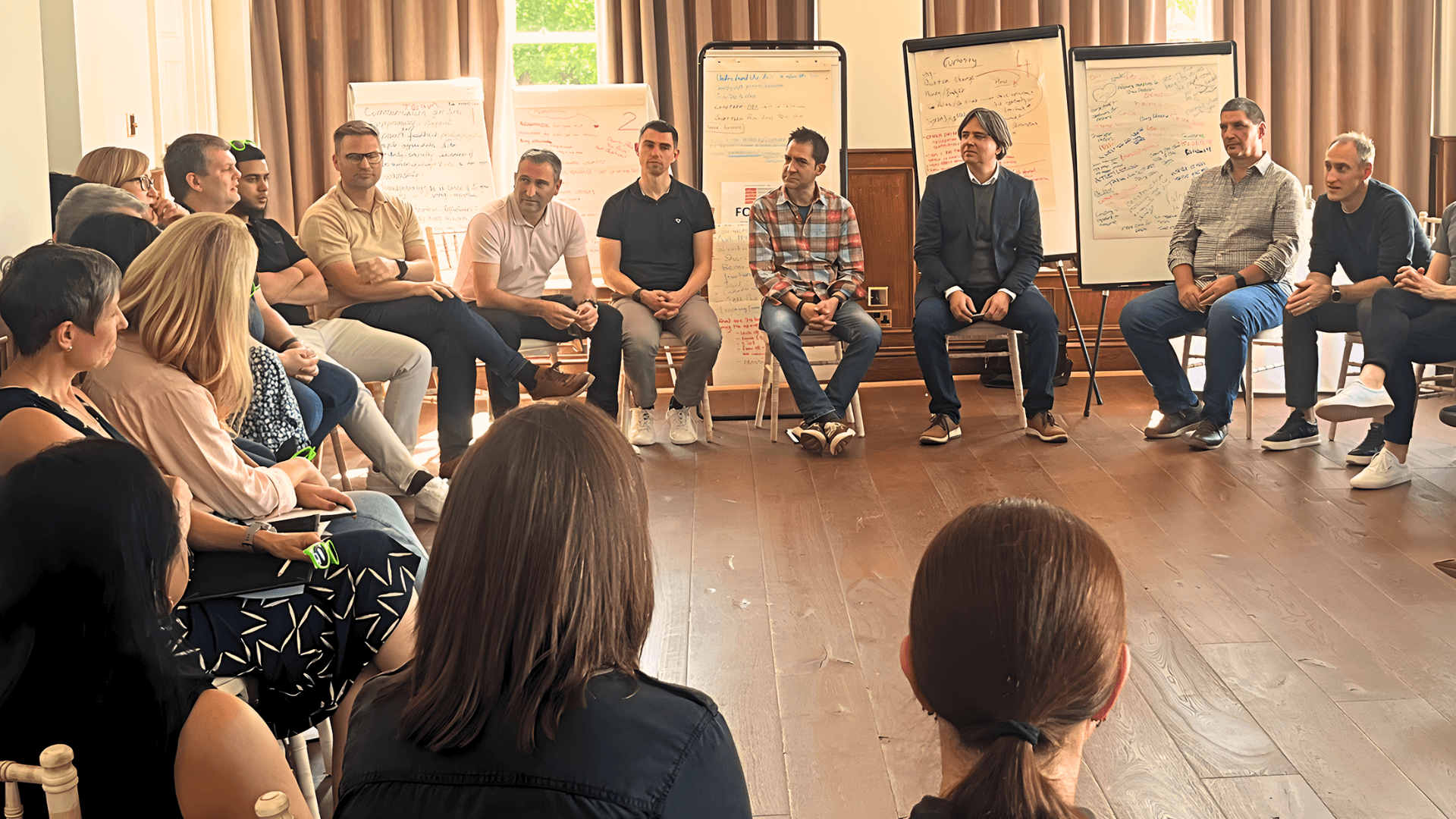 Participants in a group discussion with flip charts during a leadership session